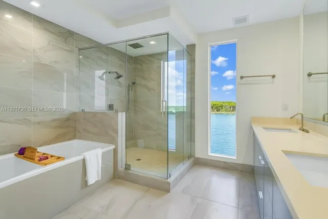 a bathroom with a tub a sink and a shower