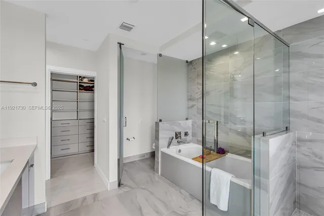 a bathroom with a bathtub and a shower