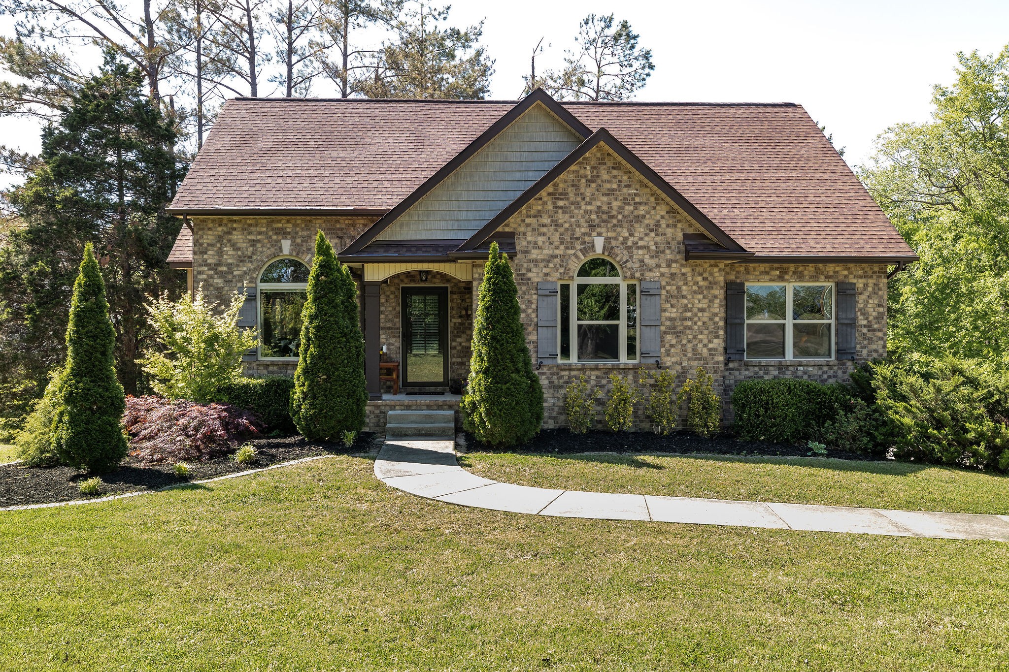a front view of a house with a yard