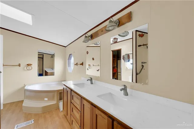 a bathroom with a double vanity sink mirror and toilet
