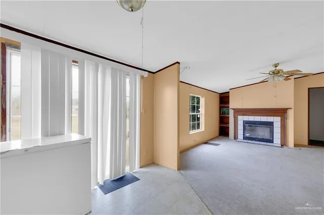 a view of a livingroom with a fireplace and window