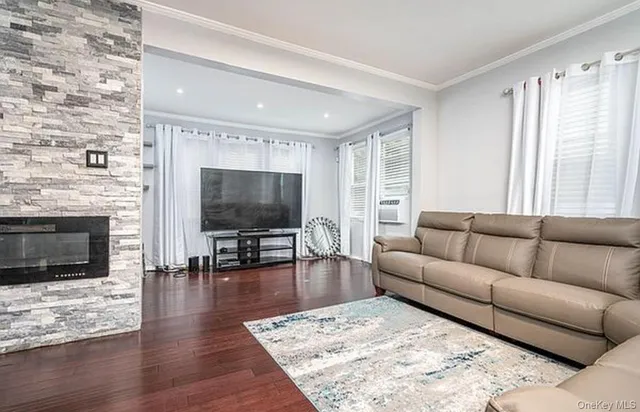 a living room with furniture flat screen tv and a fireplace