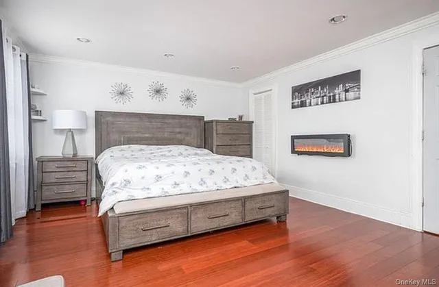 a bedroom with a bed and a night stand