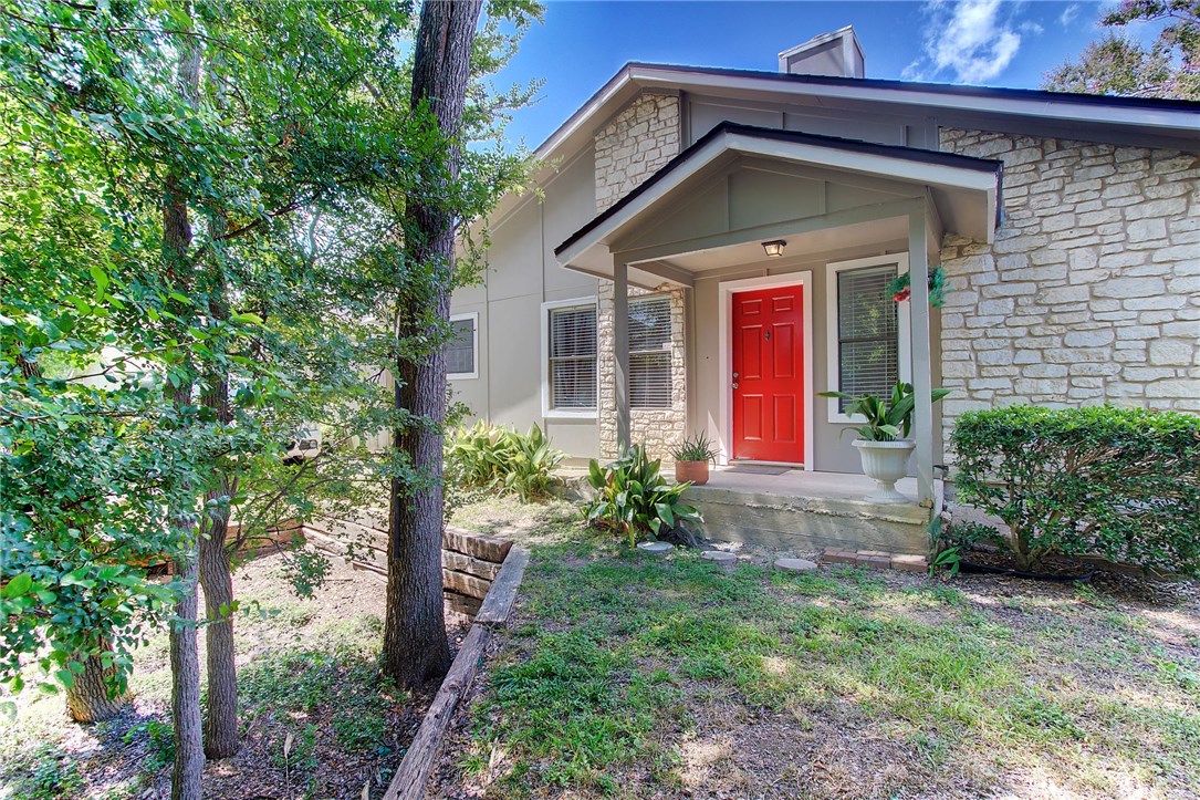 1720 Timber Ridge Road, Unit 168 Austin, TX 78741 - Photo 1 of 1 a view of a house with a small yard plants and large tree