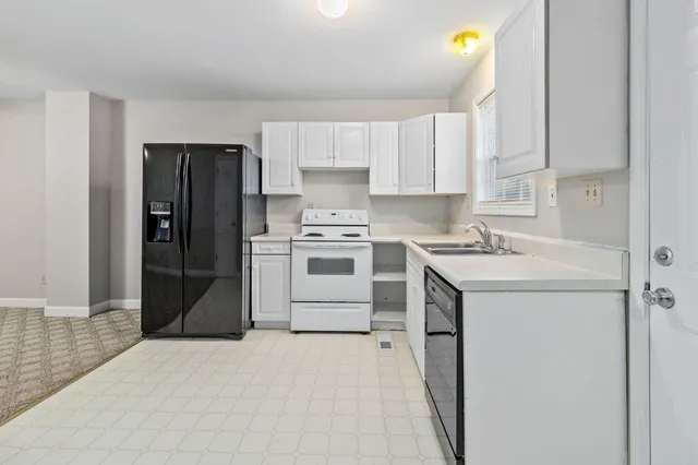 a kitchen with a sink a stove and refrigerator