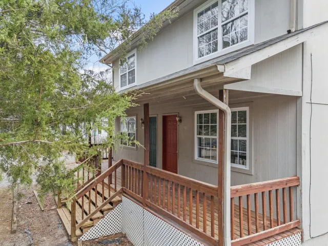 a view of a house with a small deck