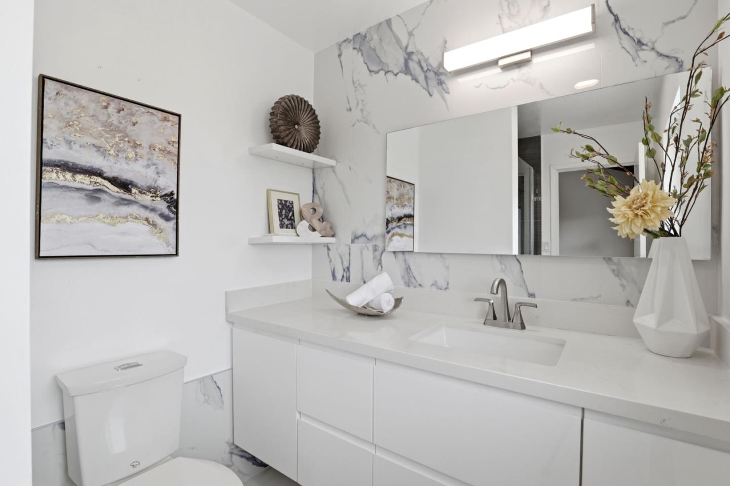 255 South Rengstorff Avenue, Unit 2 Mountain View, CA 94040 - Photo 18 of 25 a bathroom with a sink a toilet and a mirror