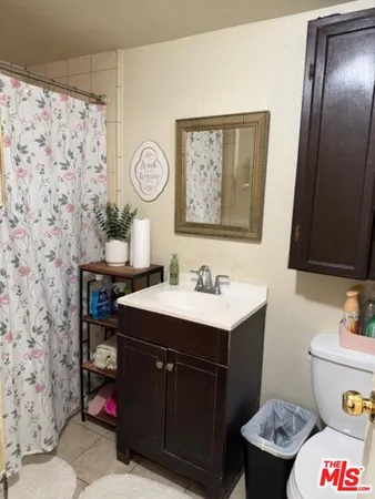 a bathroom with a sink toilet and a mirror