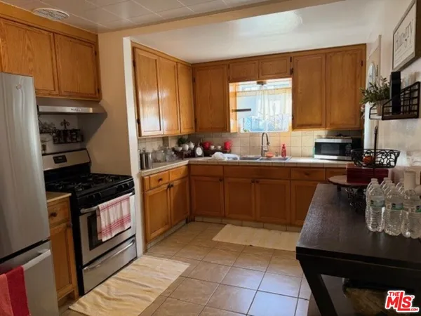 a kitchen with a sink a stove and cabinets