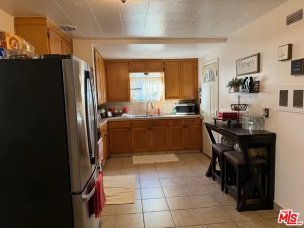 a kitchen with a sink a counter and chairs