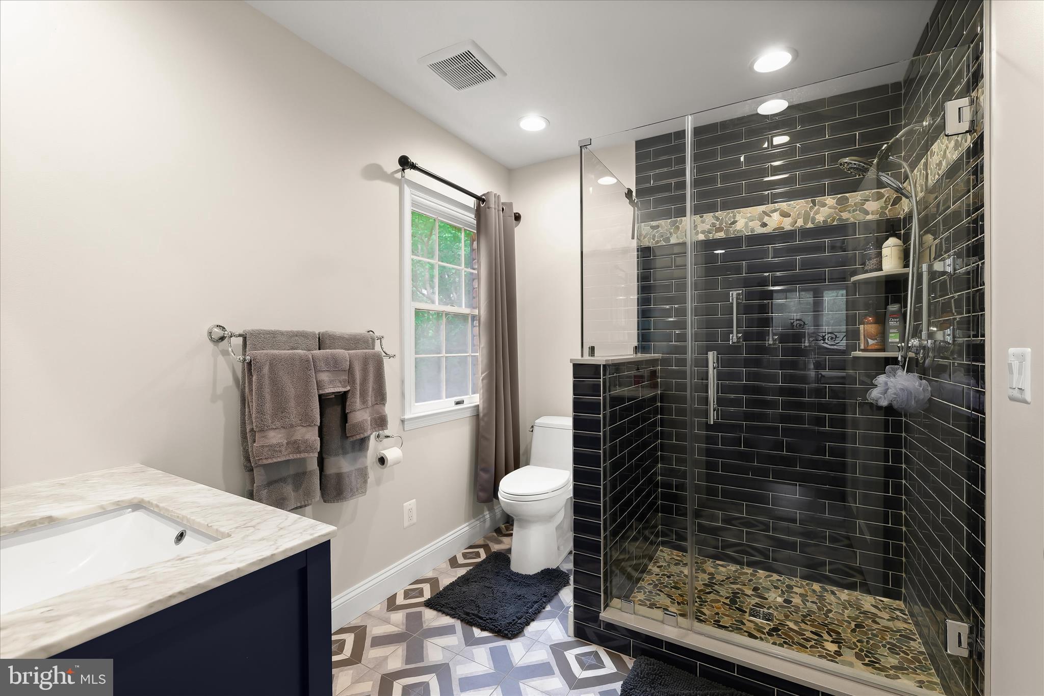 3754 Patuxent River Road Davidsonville, MD 21035 - Photo 23 of 82 a bathroom with a sink a toilet and shower