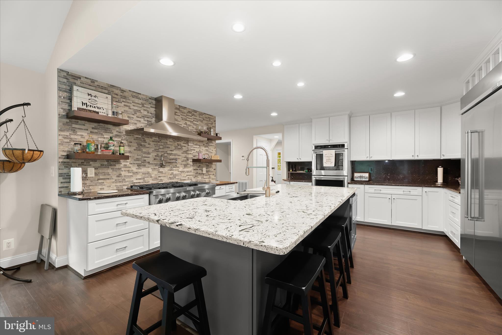 3754 Patuxent River Road Davidsonville, MD 21035 - Photo 5 of 82 a kitchen with stainless steel appliances kitchen island granite countertop a table chairs sink and cabinets