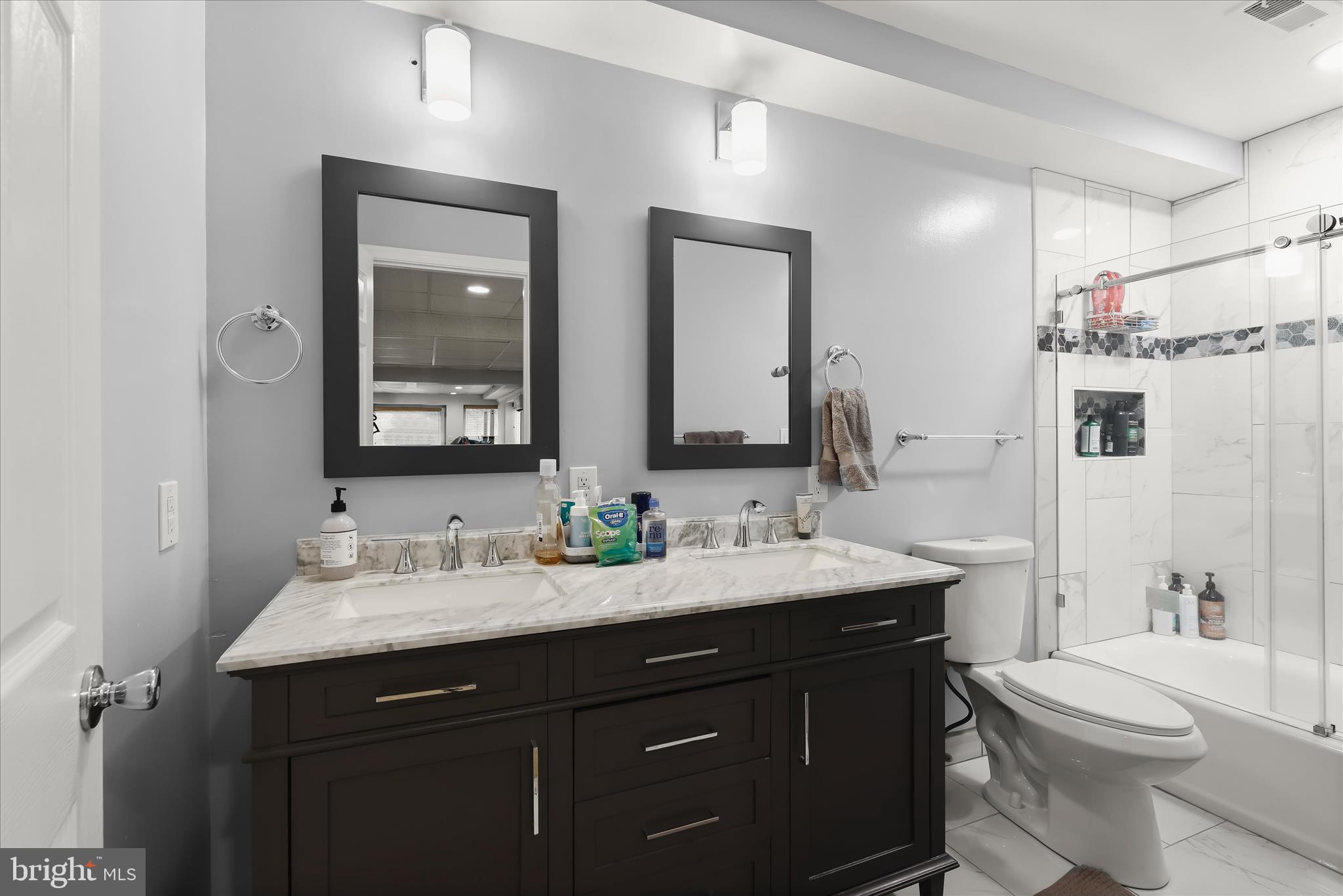 3754 Patuxent River Road Davidsonville, MD 21035 - Photo 51 of 82 a bathroom with a double vanity sink toilet and a mirror