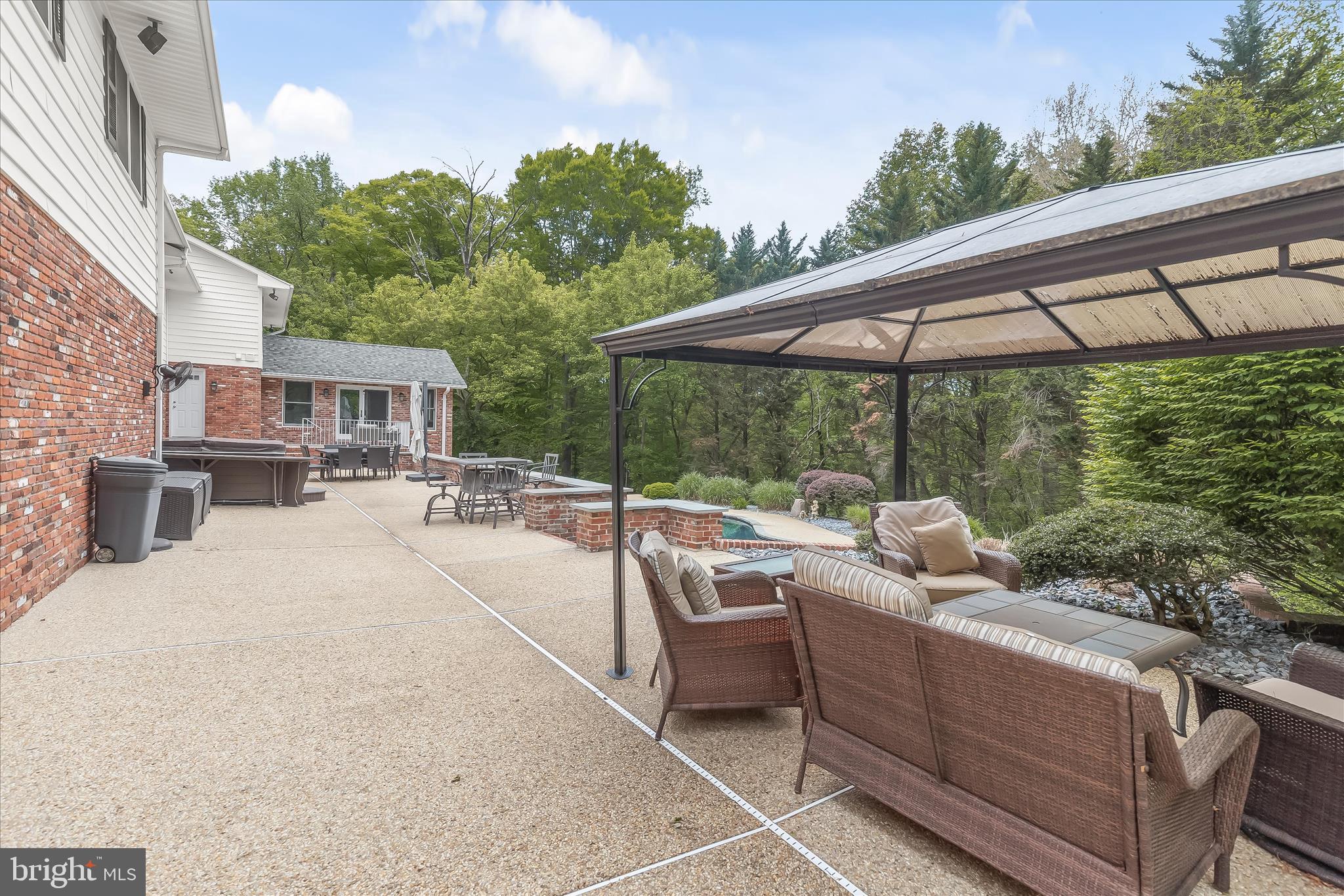 3754 Patuxent River Road Davidsonville, MD 21035 - Photo 66 of 82 a patio with patio a table and chairs under an umbrella