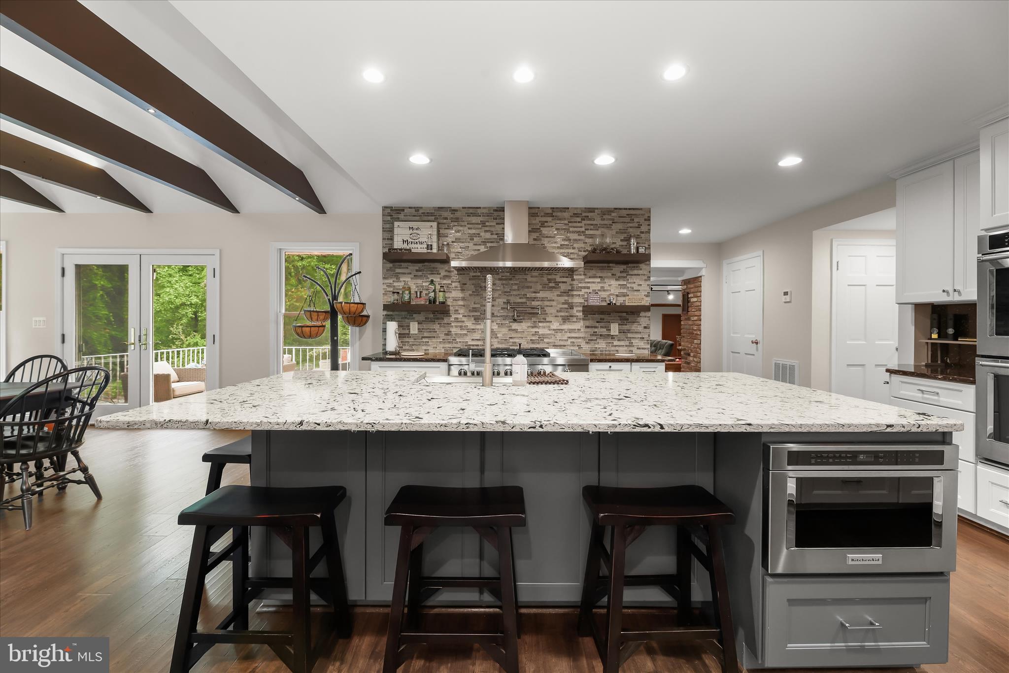 3754 Patuxent River Road Davidsonville, MD 21035 - Photo 8 of 82 a kitchen with granite countertop kitchen island cabinets and chairs in it