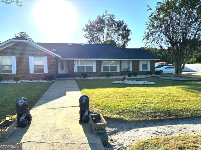 a view of a house with swimming pool next to a yard