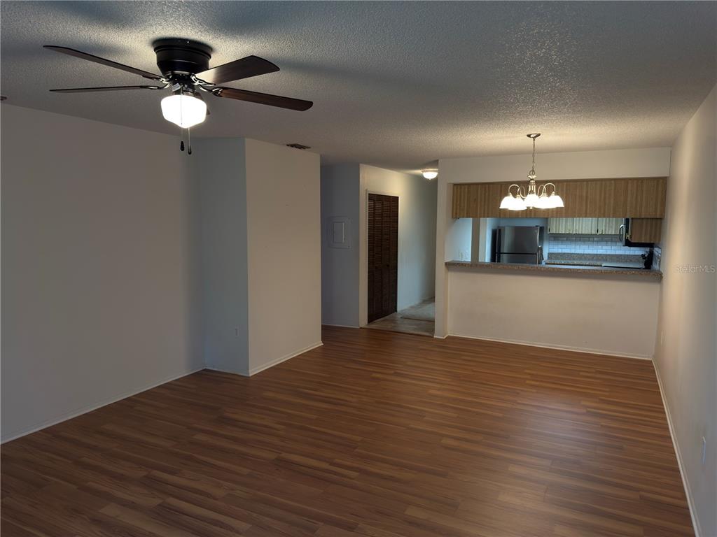 12155 Environmental Drive, Unit 6 New Port Richey, FL 34654 - Photo 14 of 31 a view of a livingroom with a ceiling fan window and wooden floor