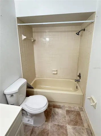 a white toilet sitting next to a bathroom sink