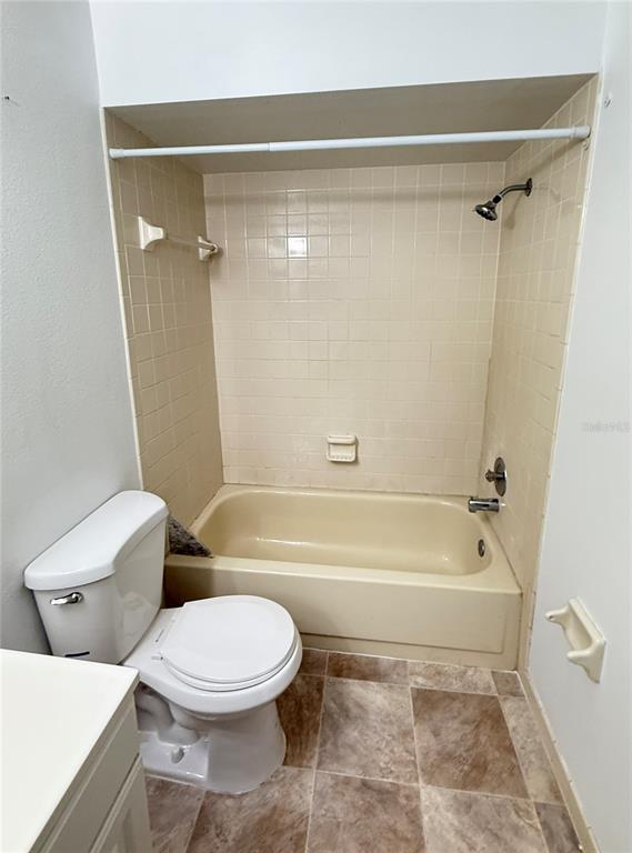 12155 Environmental Drive, Unit 6 New Port Richey, FL 34654 - Photo 20 of 31 a bathroom with a toilet and a bath tub