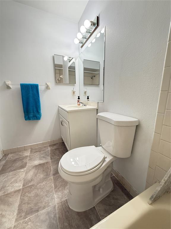 12155 Environmental Drive, Unit 6 New Port Richey, FL 34654 - Photo 21 of 31 a white toilet sitting next to a bathroom sink