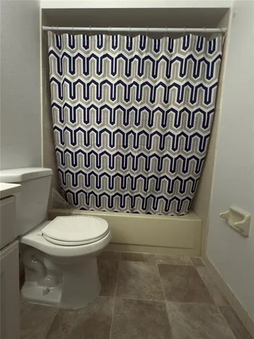 a view of a livingroom with a ceiling fan and window