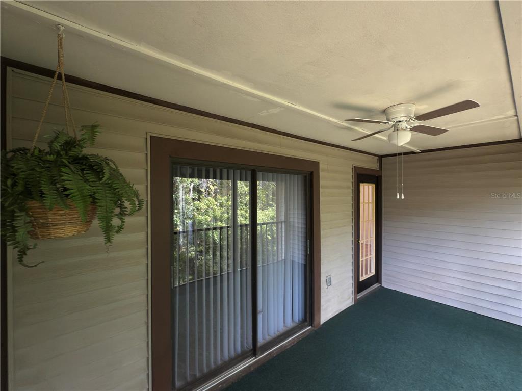 12155 Environmental Drive, Unit 6 New Port Richey, FL 34654 - Photo 24 of 31 a view of a livingroom with a ceiling fan and window