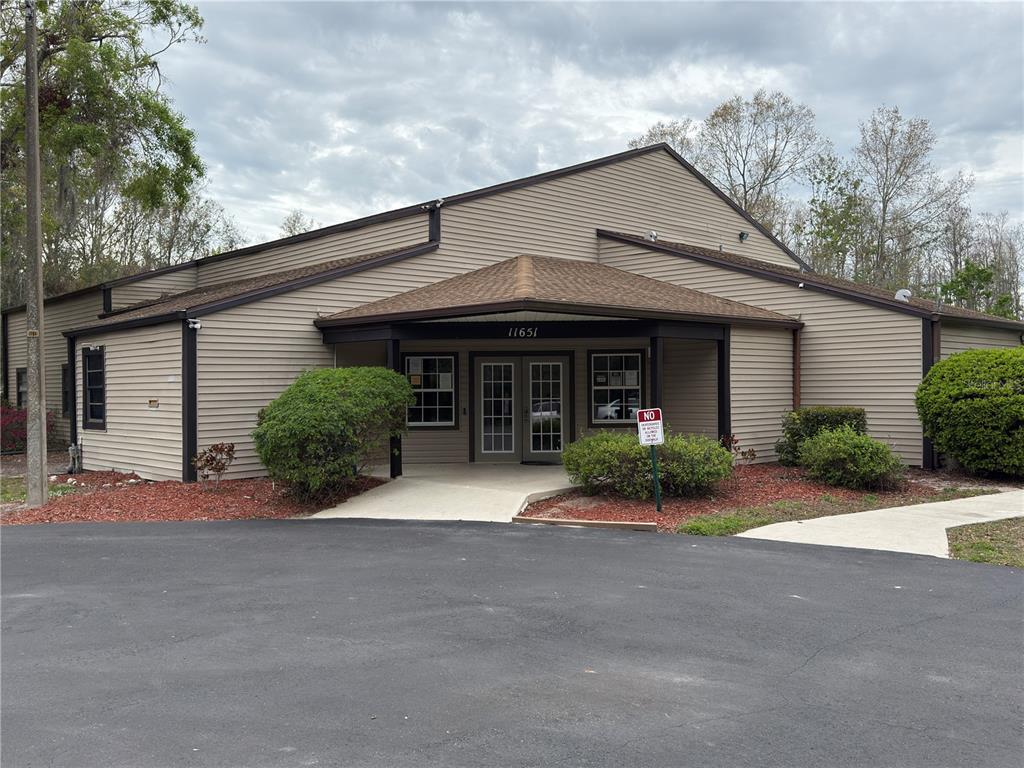 12155 Environmental Drive, Unit 6 New Port Richey, FL 34654 - Photo 27 of 31 a front view of a house with garden and parking