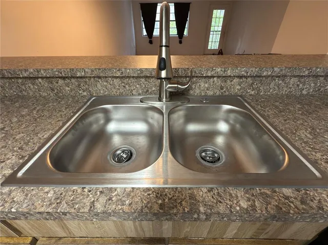 a kitchen with granite countertop a refrigerator stove and microwave