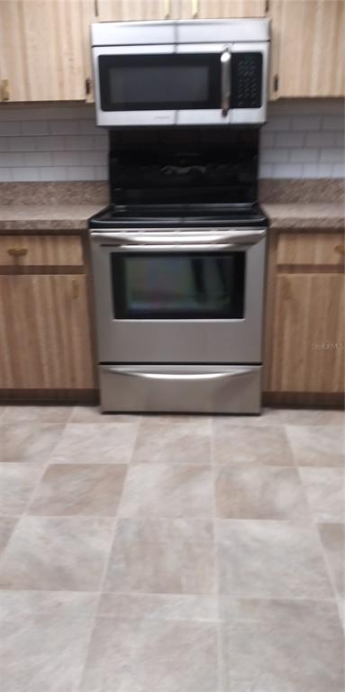 12155 Environmental Drive, Unit 6 New Port Richey, FL 34654 - Photo 10 of 31 a stove top oven sitting inside of a kitchen