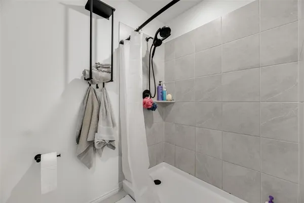 a bathroom with a shower and a shower