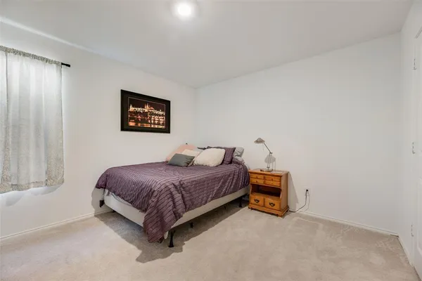 a spacious bedroom with a bed and a window