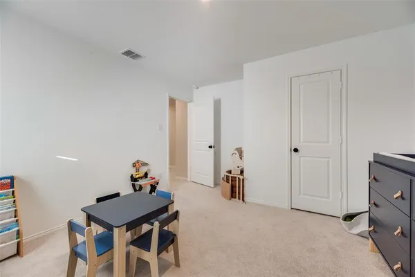 a view of a room with furniture and wooden floor
