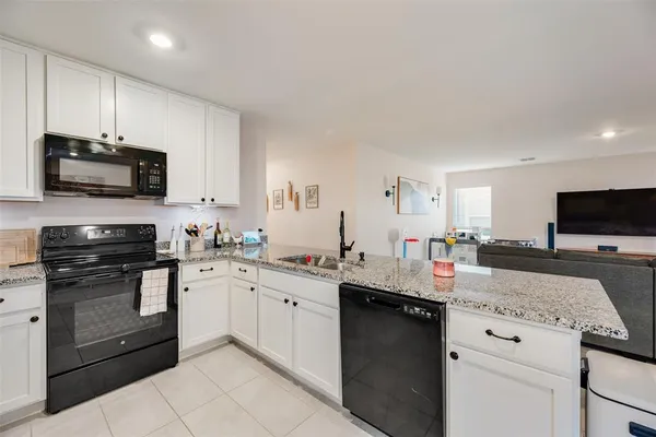 a kitchen with a sink stove and microwave