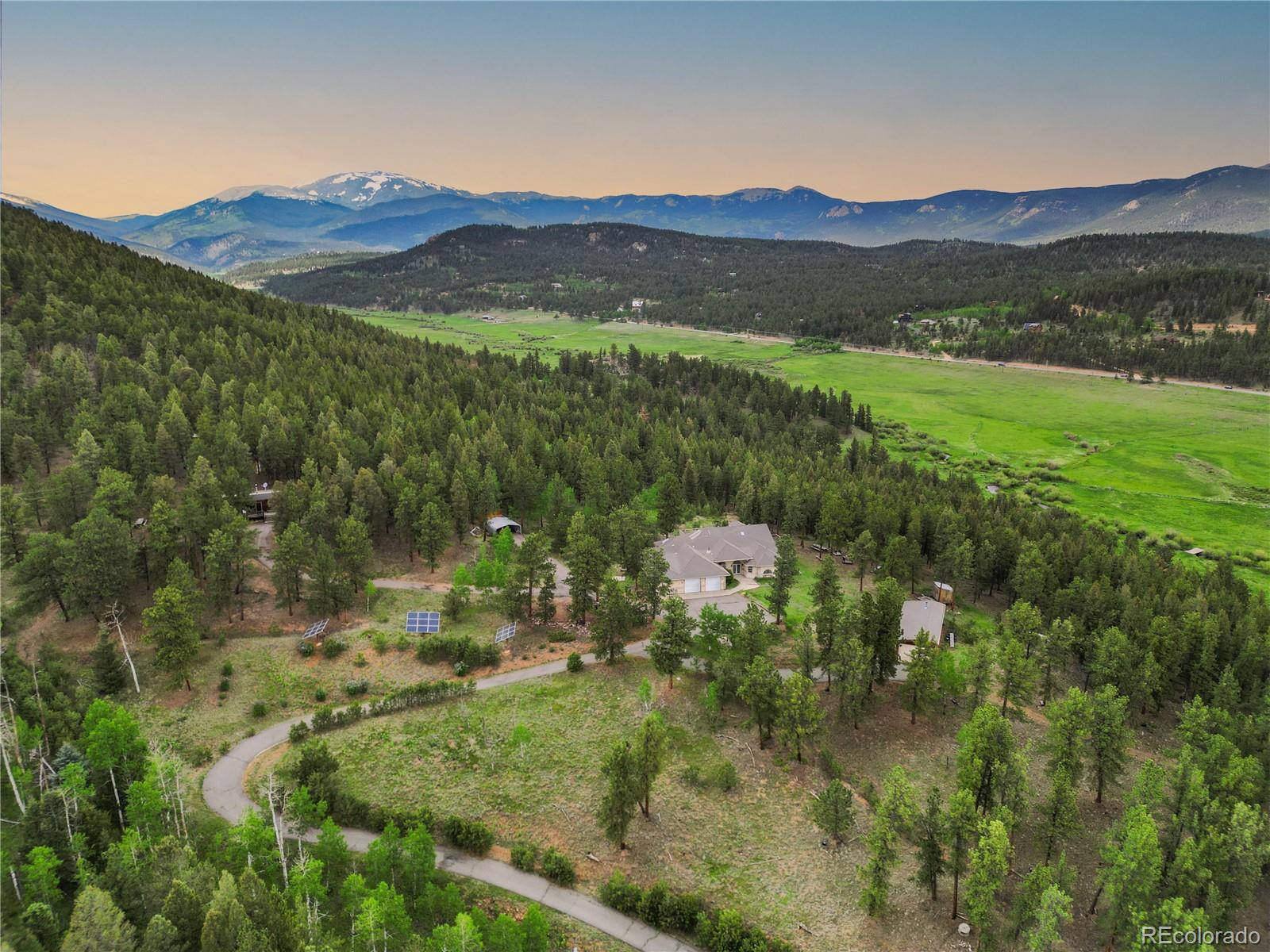 3763 County Road 43 Bailey, CO 80421 - Photo 2 of 40 a view of a lush green hillside and houses