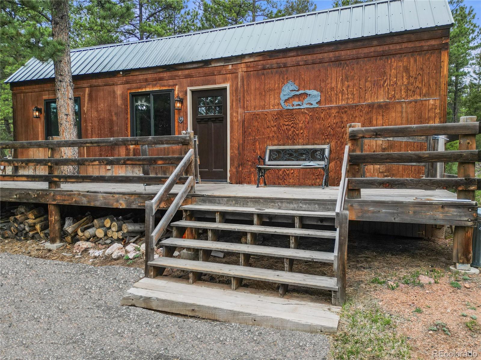 3763 County Road 43 Bailey, CO 80421 - Photo 23 of 40 a view of house with deck and a yard