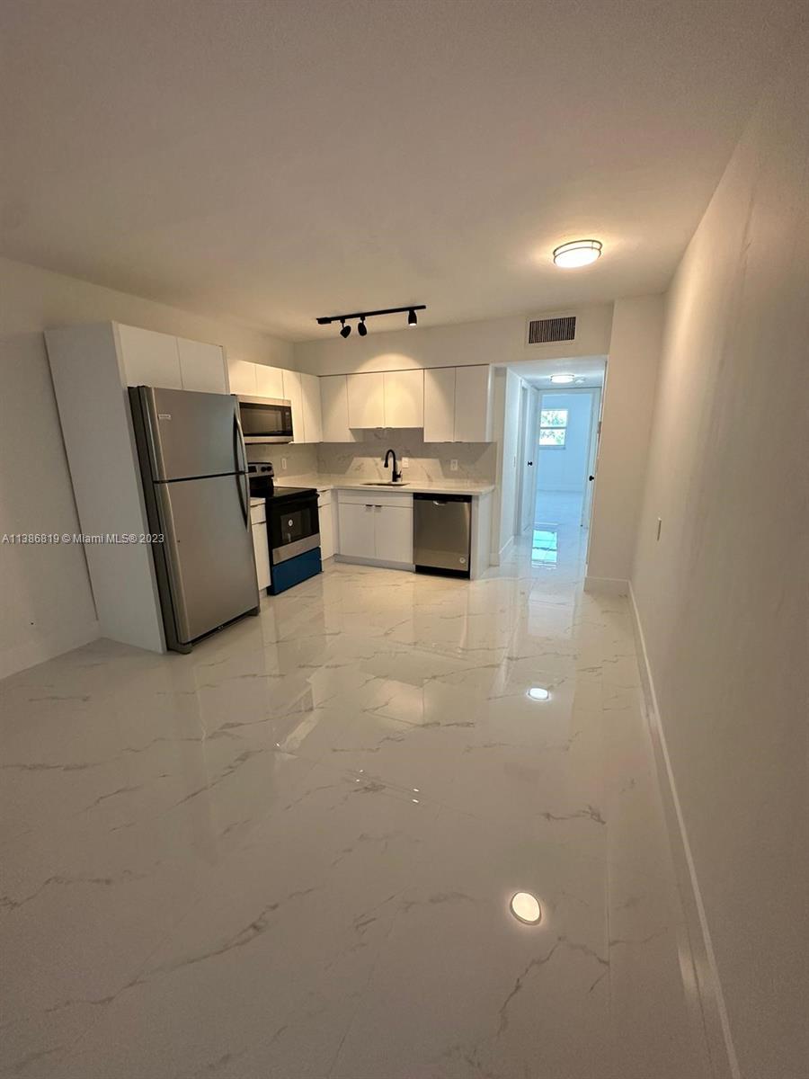 1740 Funston Street, Unit 12 Hollywood, FL 33020 - Photo 2 of 10 a view of a livingroom with furniture and white walls