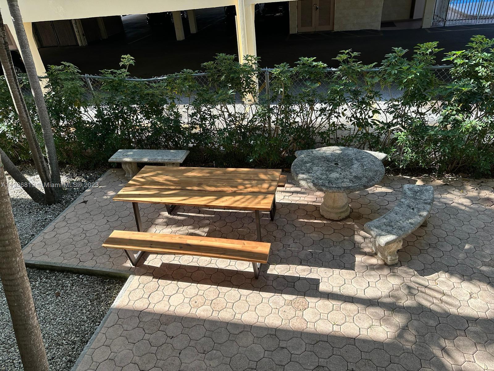 1740 Funston Street, Unit 12 Hollywood, FL 33020 - Photo 8 of 10 a view of a patio with chairs and potted plants