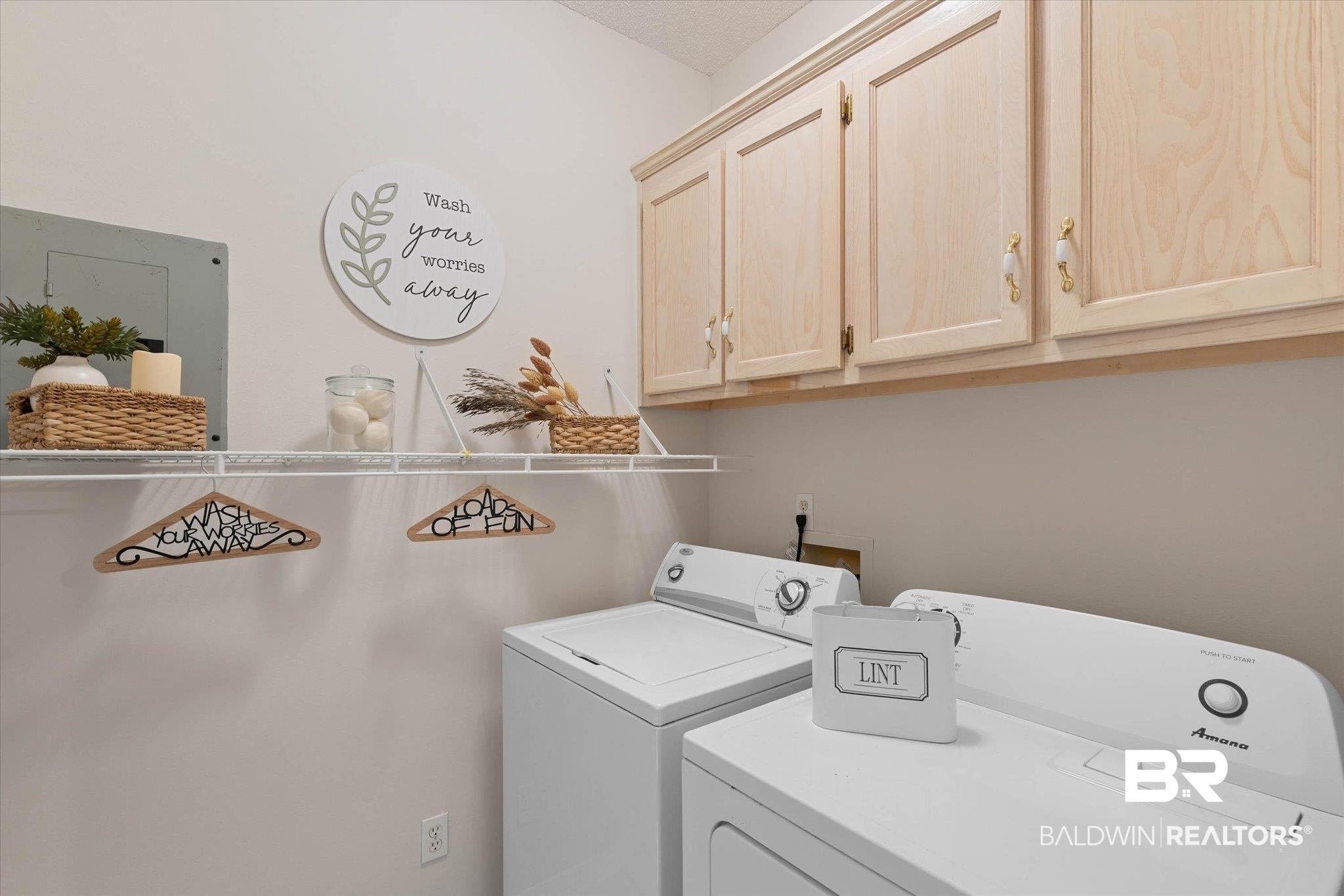 3170 Scott Dairy Loop Road West Mobile, AL 36695 - Photo 17 of 24 Dedicated laundry area featuring overhead cabinetry, a wire shelving unit, and neutral wall paint
