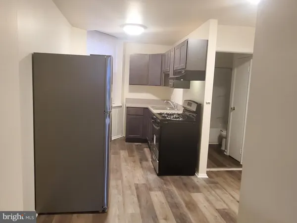 a kitchen with stainless steel appliances granite countertop a refrigerator and a stove