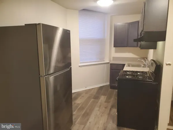 a kitchen with metallic refrigerator freezer and a dishwasher