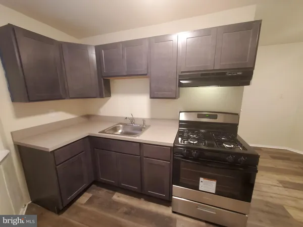 a kitchen with a stove and a sink