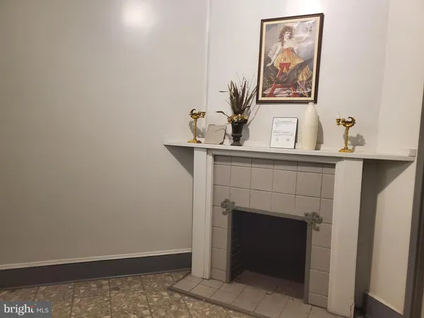 a room with a fireplace and potted plant