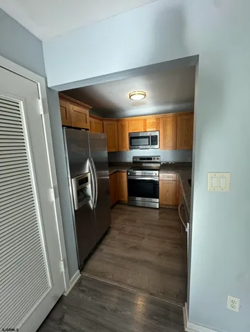 a kitchen with granite countertop a stove and a sink