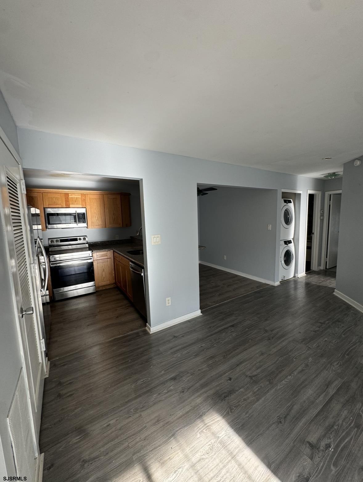 275 Heather Croft, Unit 275 Egg Harbor Township, NJ 08234 - Photo 10 of 23 an empty room with wooden floor kitchen view and a window
