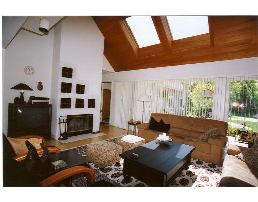 232 Tower Road Lincoln, MA 01773 - Photo 4 of 7 a living room with furniture a fireplace and a flat screen tv