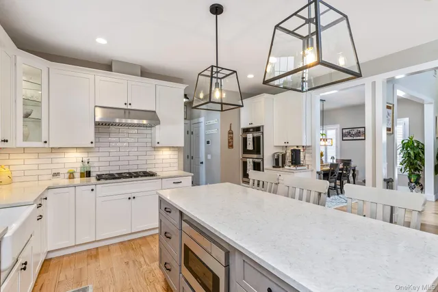 a kitchen with stainless steel appliances kitchen island granite countertop a sink and cabinets