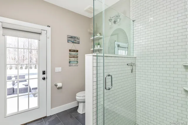 a bathroom with a toilet sink and shower