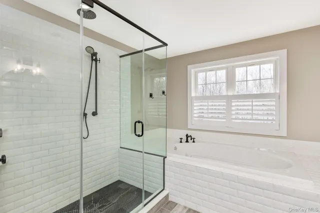 a bathroom with a bathtub and shower