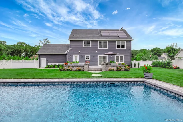 a front view of a house with a yard and road