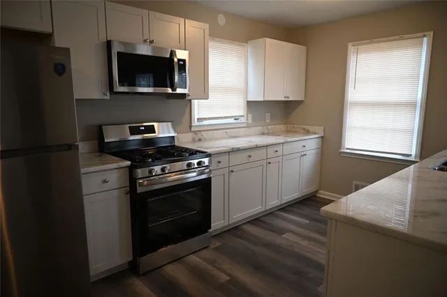 a kitchen with a sink stove and microwave